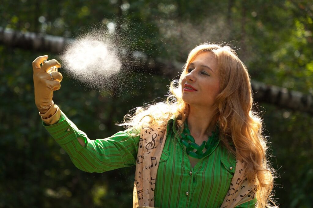 A girl spraying perfume